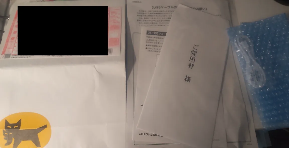 左から返送用の袋、返送手順やリコールの謝罪文などの文書、USBケーブル